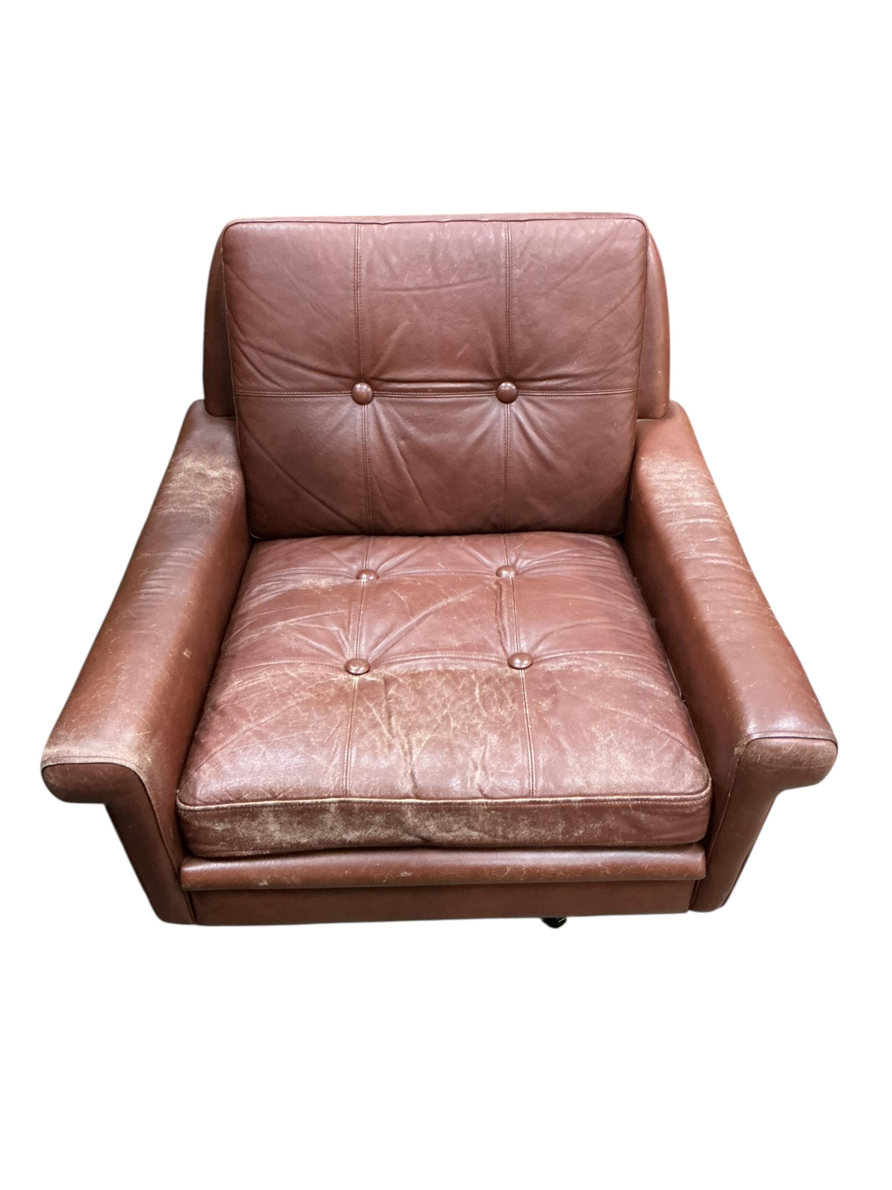 A Danish mid century Svend Skipper brown leather swivel lounge chair on five prong chrome base, width 74cm, depth 76cm, height 70cm